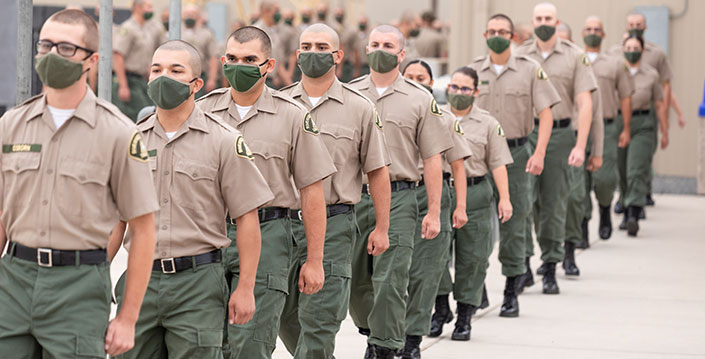 BCTC law enforcement graduates line up in uniforms for a graduation and recognition ceremony