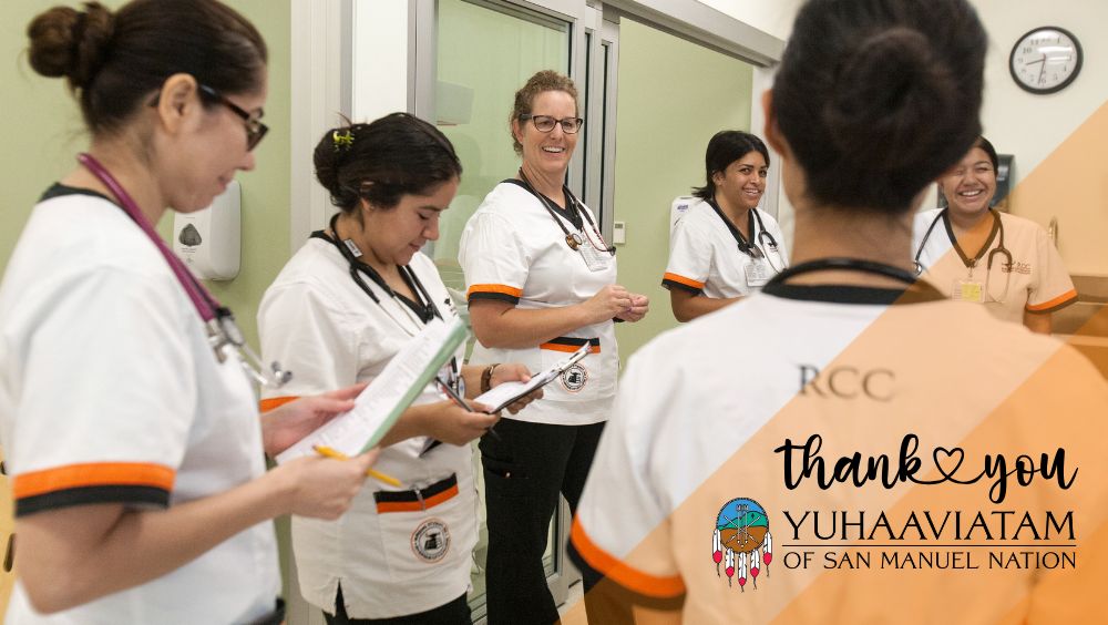RCC Nursing students in scrubs converse with their professor during a simulation